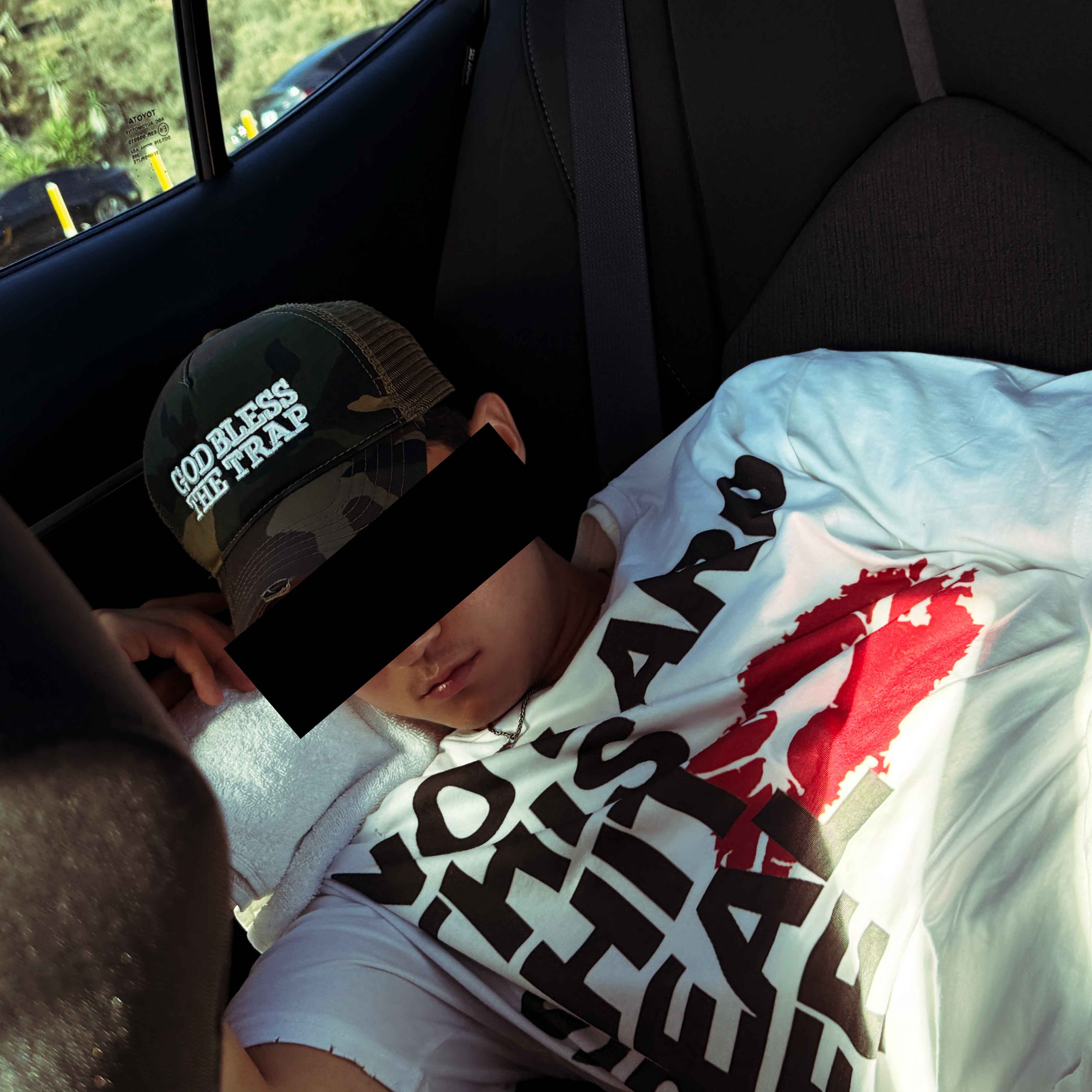 No LARP T-shirt worn while resting in a car