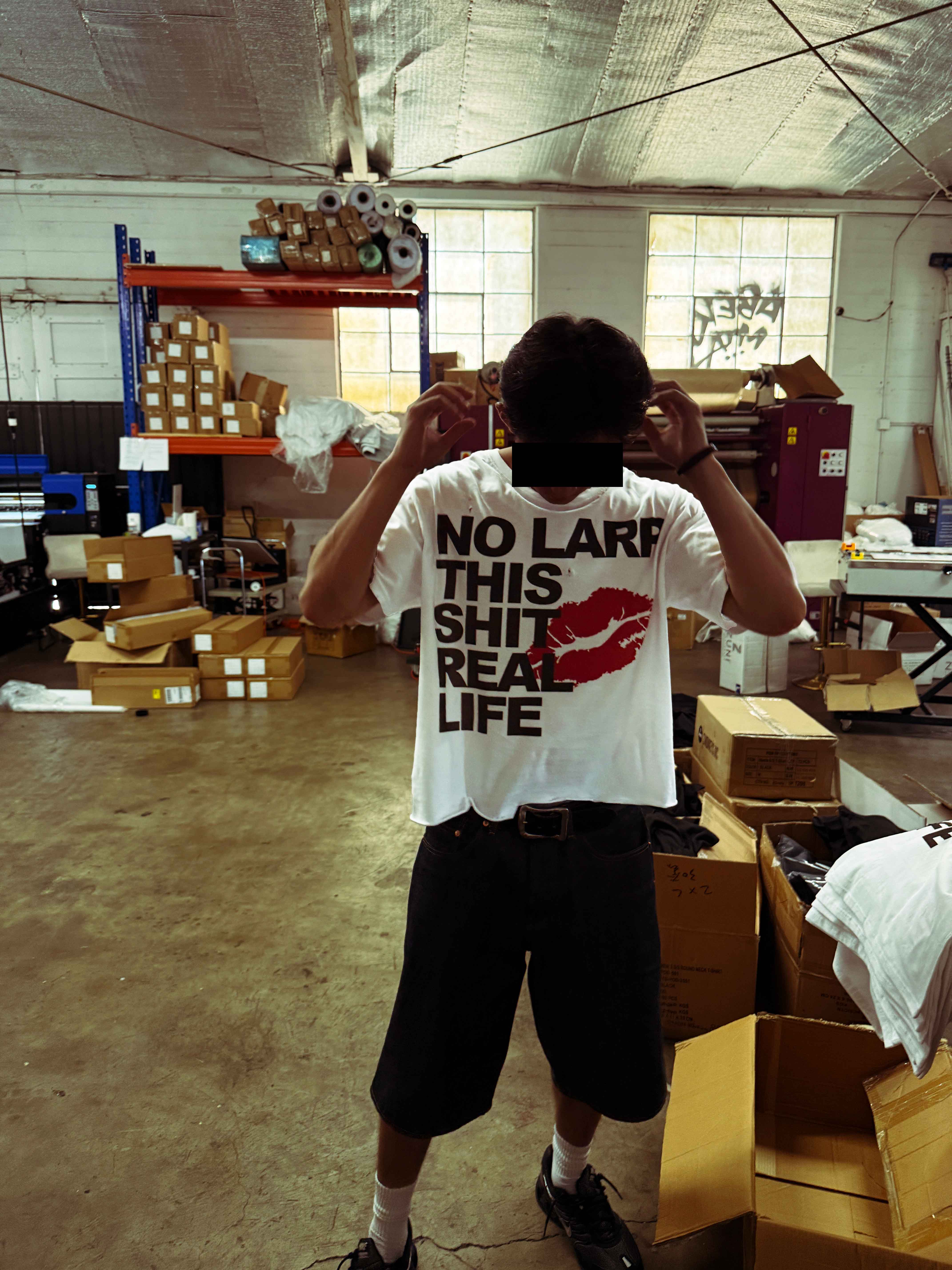 No LARP T-shirt worn in a working warehouse